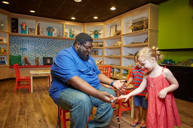 teacher showing children a snake